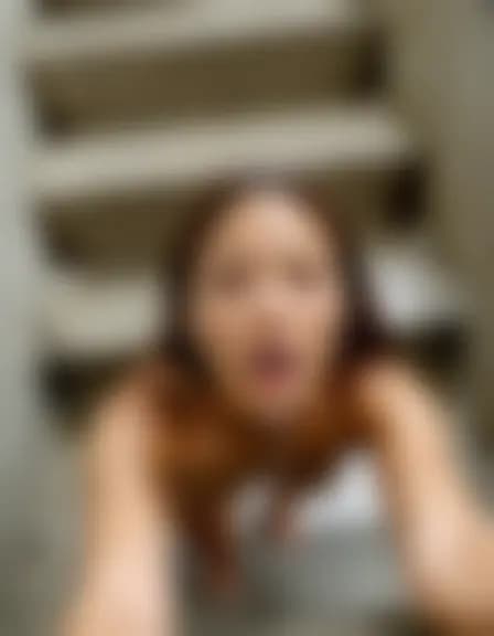 Leah receives a facial cumshot on a narrow stairwell.