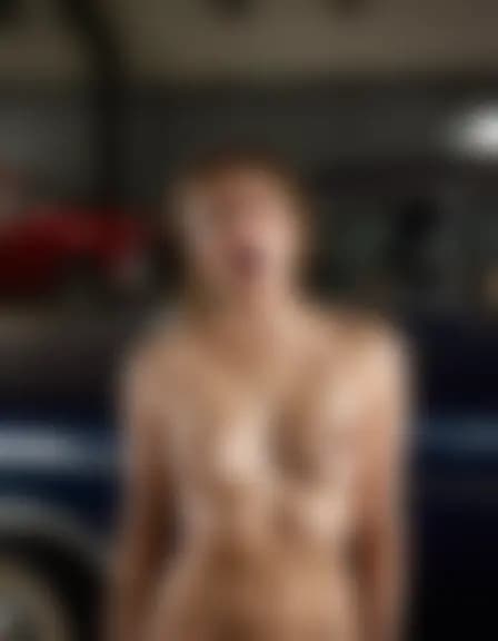 Abigail orgasms in a shadowy classic car service center.