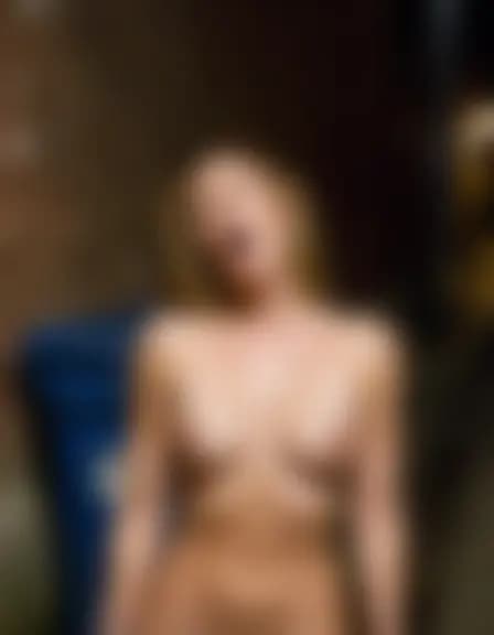 Olivia, a woman, climaxing in a narrow alleyway at night.