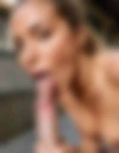 Ella getting a blowjob in an urban courtyard.