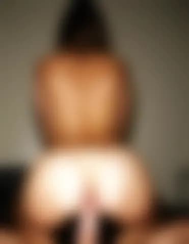 Zoe in a sensual cowgirl position, serene massage room.