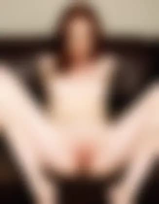 Evelyn masturbating in a minimalist apartment living room.